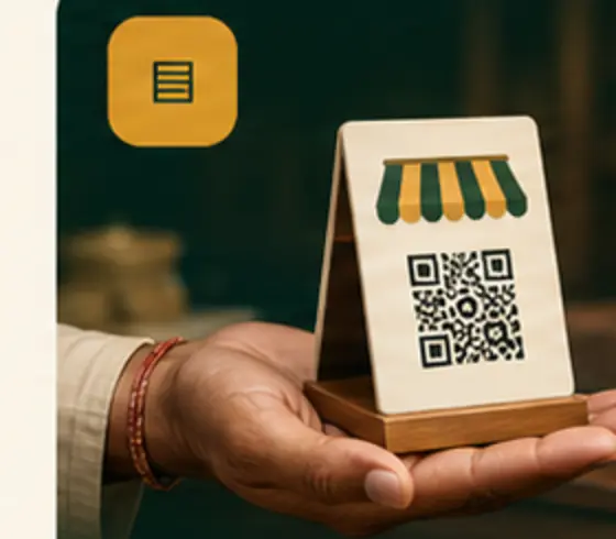 A merchant's hand presenting their own shop QR